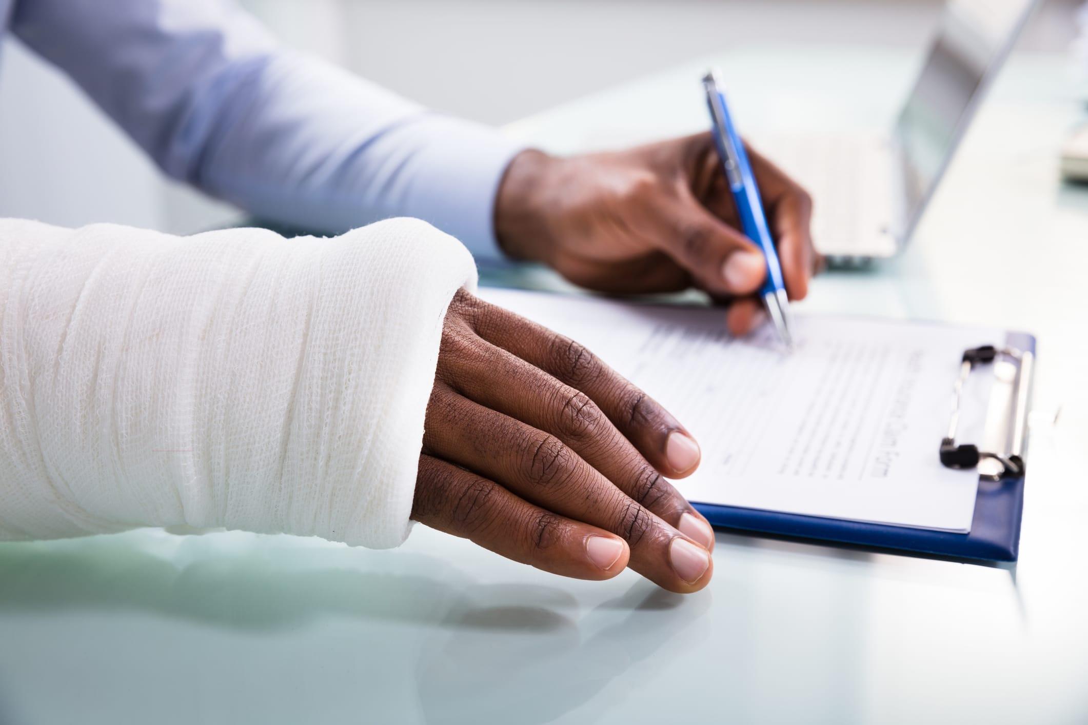An injured worker filling out their accident claim.
